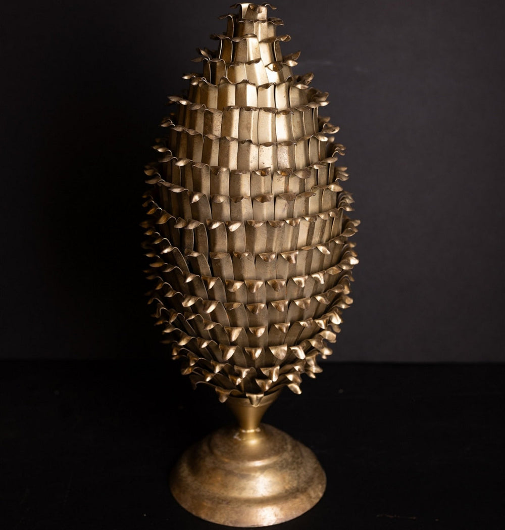 Decorative metallic sculpture resembling a tree on a black background