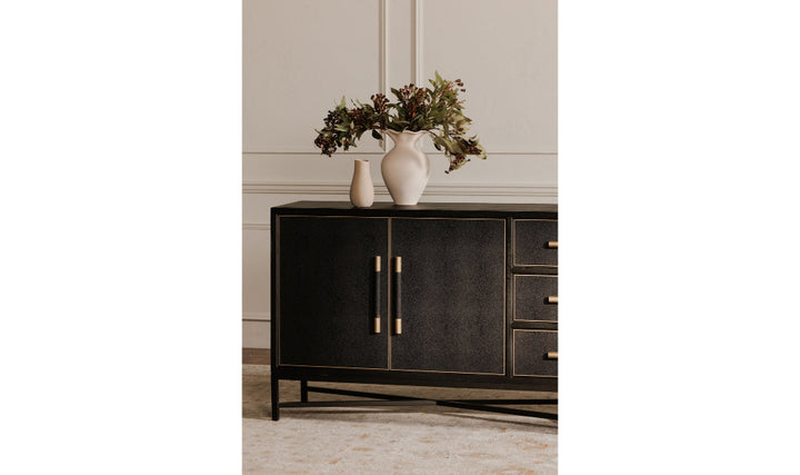 Dark wooden sideboard with gold handles against a neutral wall.