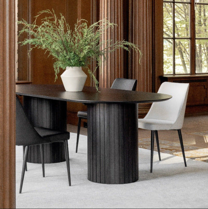 Dining room with a dark wooden table, chairs, and a large window.