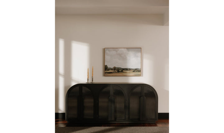 Modern black sideboard in a room with a painting on the wall.