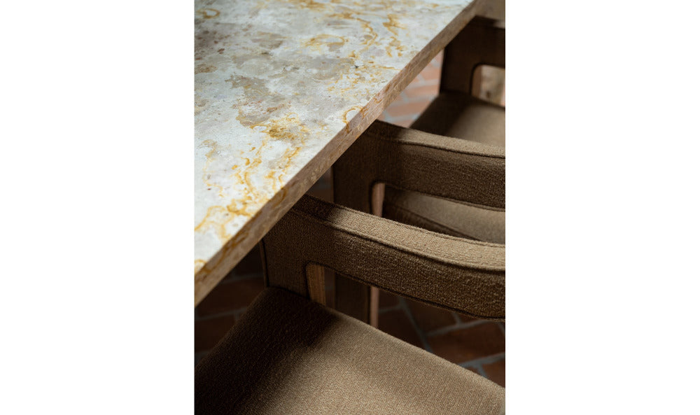 Close-up of a marble countertop with a chair underneath