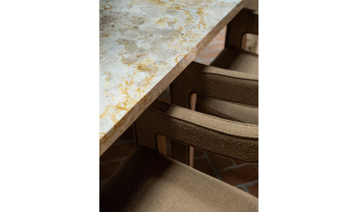 Close-up of a marble countertop with a chair underneath
