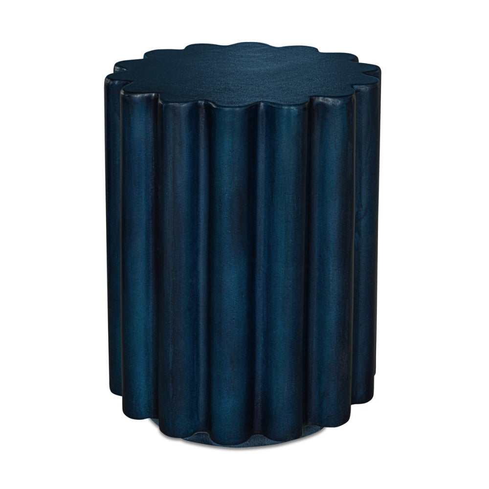 Blue cylindrical side table with scalloped edge on a white background