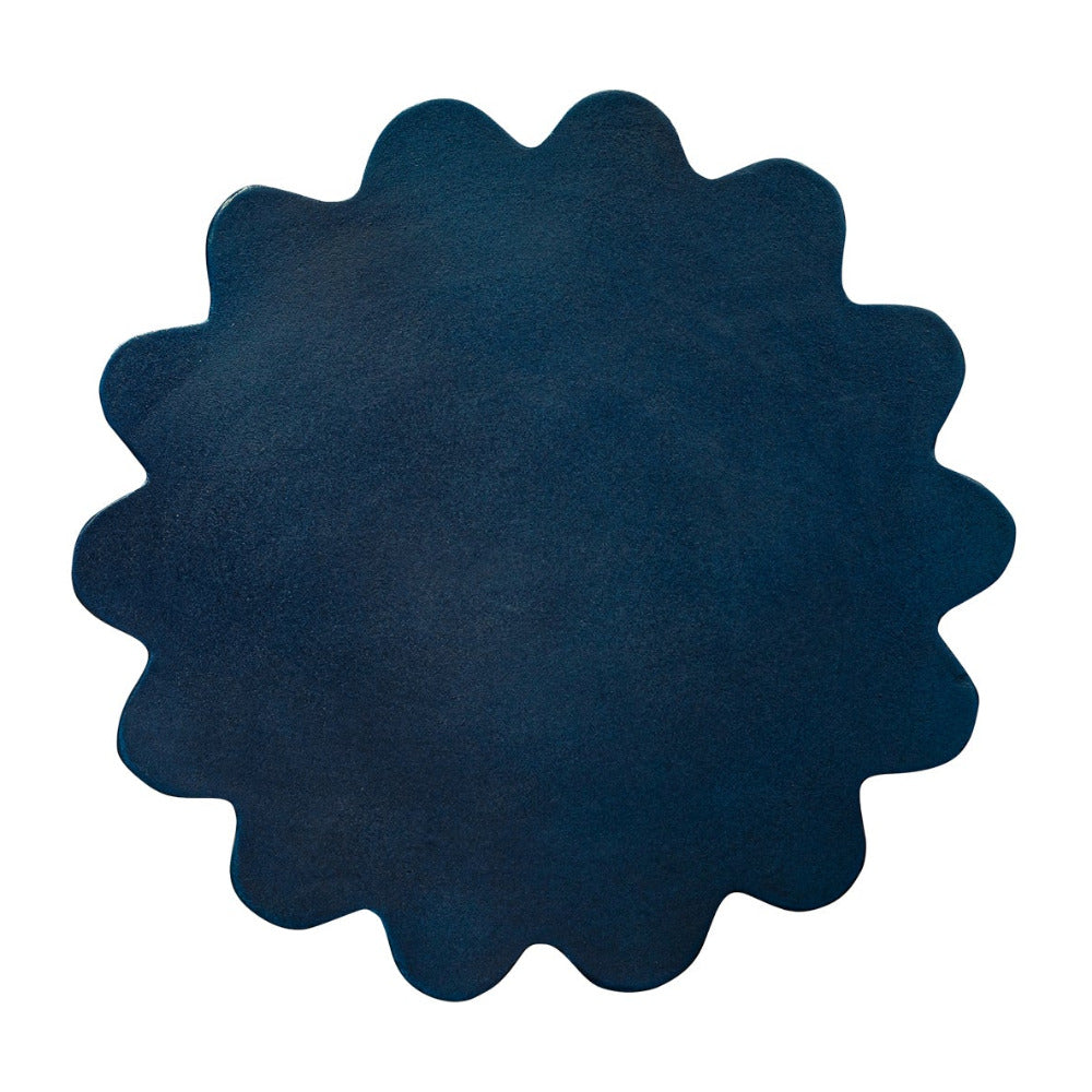 Navy blue circular table with scalloped edge on a white background