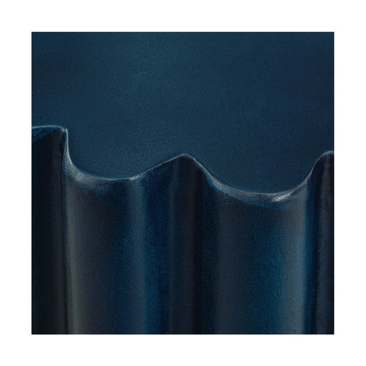 Close-up of navy blue table with a scalloped edge on a white background