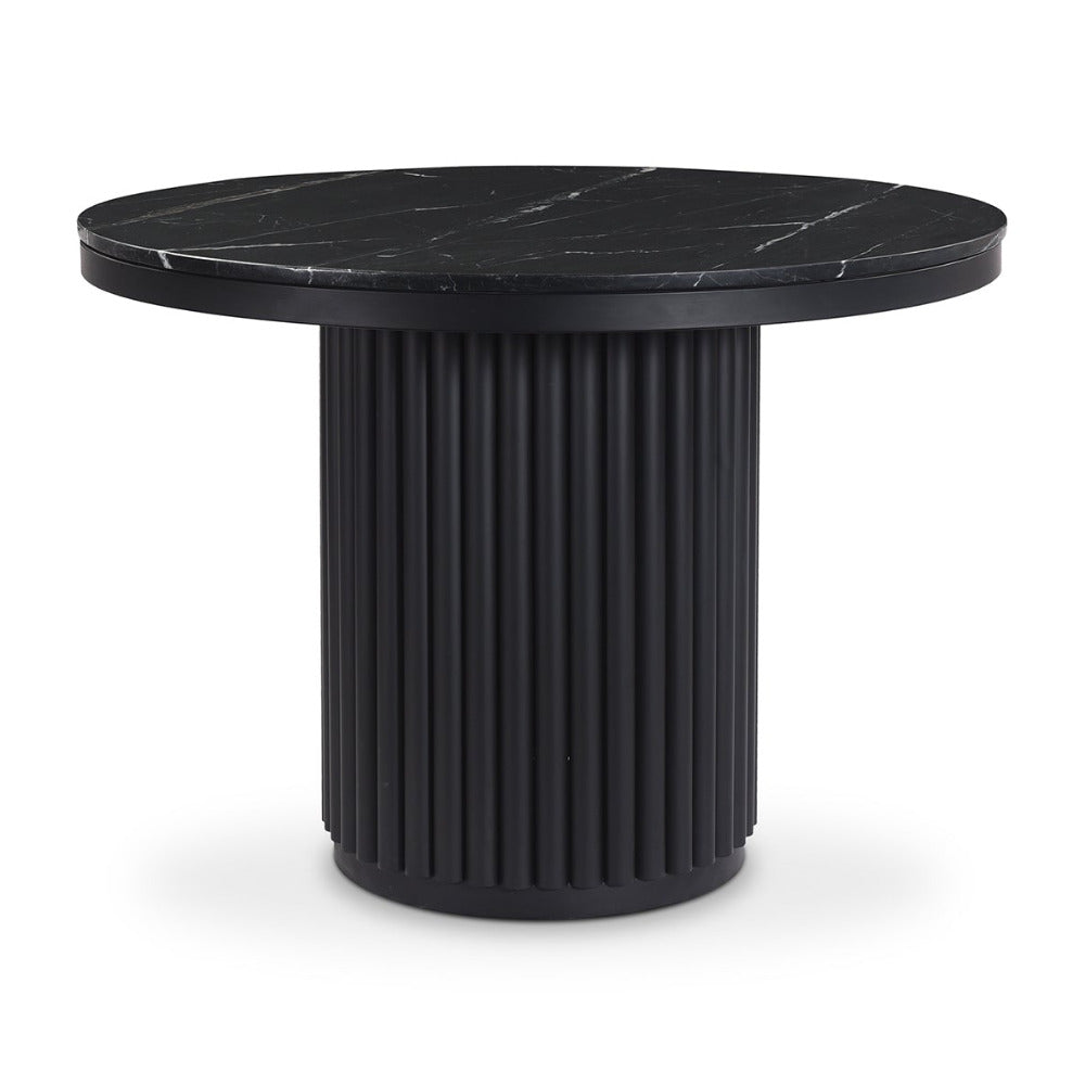 Black marble top table with ribbed cylindrical base on a white background