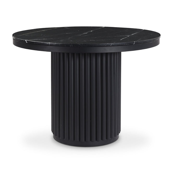 Black marble top table with ribbed cylindrical base on a white background