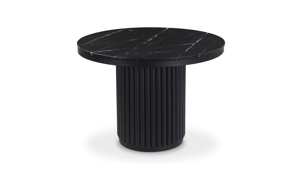 Black round table with marble-like top on a white background