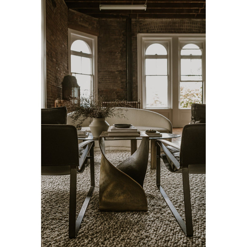 Dining room with a glass table and chairs in a rustic setting