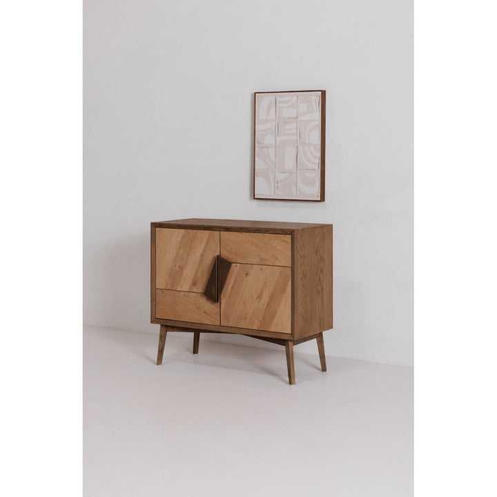 Wooden sideboard with a framed print on a white background