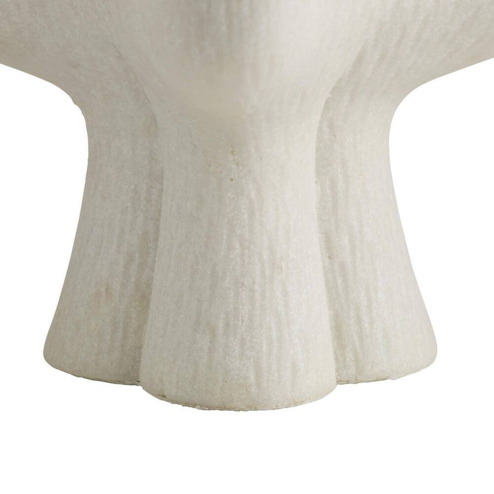 Close-up of candle holder with a textured white surface with a blurred background