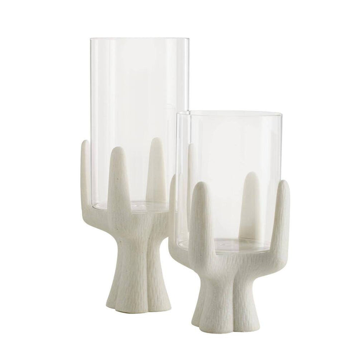 Two glass candle holders with white wooden bases on a white background