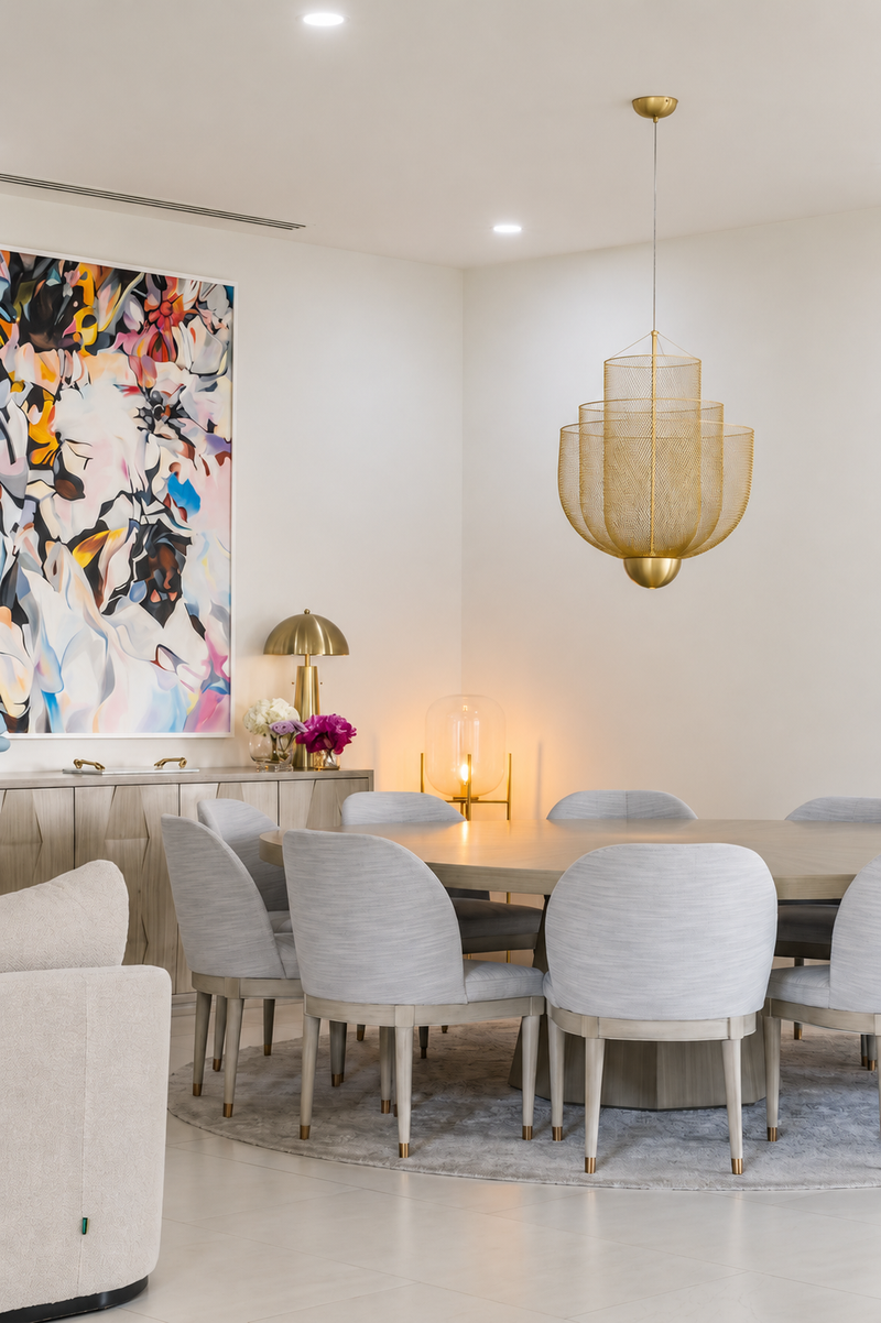 Warm modern dining room with boucle chairs, an oak credenza and a large abstract canvas