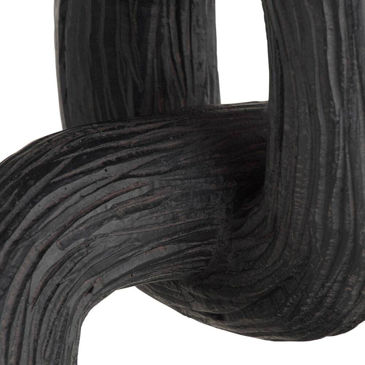Close-up of black sculpture on a white background