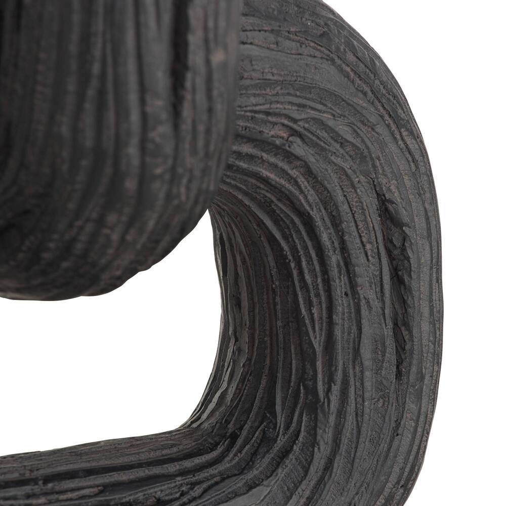 Close-up of a roll of black sculpture on a white background