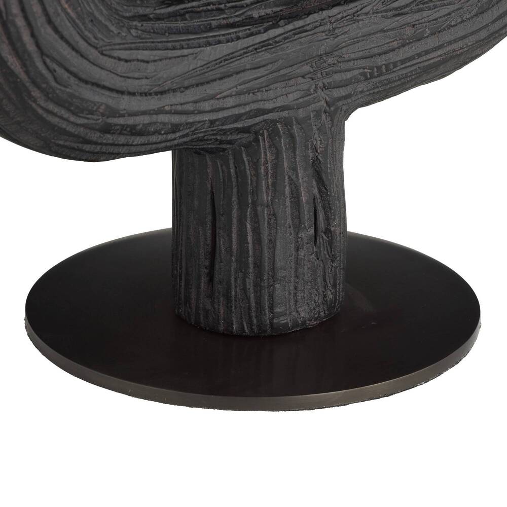 Close-up of a textured black sculpture with a round base on a white background