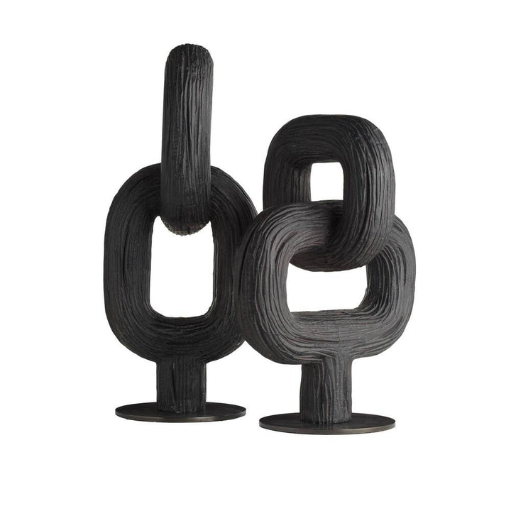 Pair of black abstract sculptures on a white background