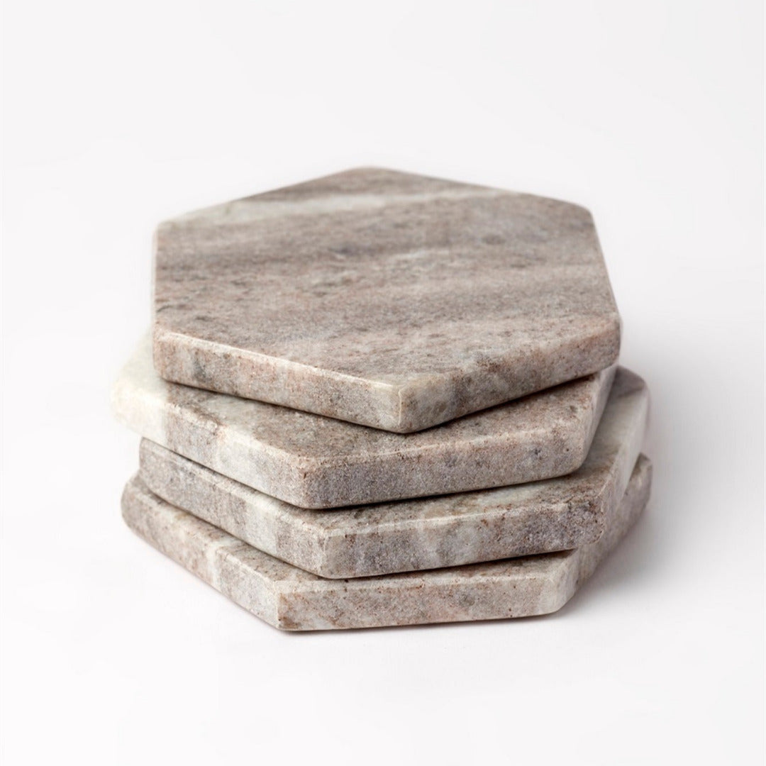 Brown hexagonal marble pieces stacked on a white background.