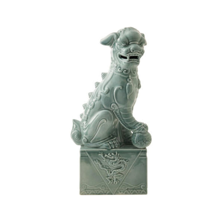 Blue glazed ceramic Foo Dog sculpture, left-facing, on white background