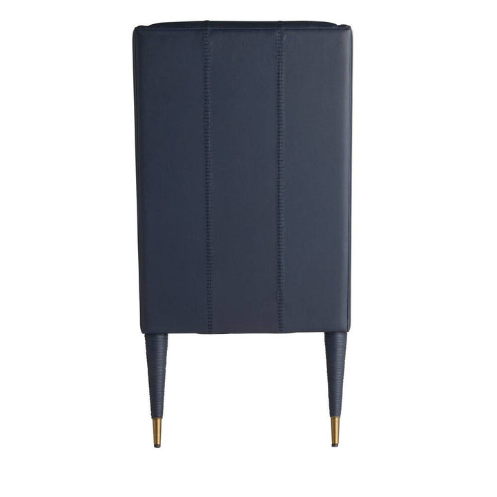 Black upholstered chair with gold legs on a white background