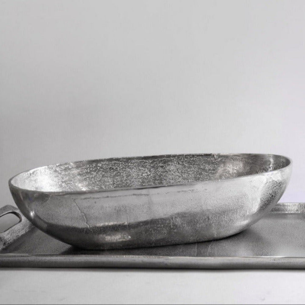 Two metallic bowls on a tray with a plain background