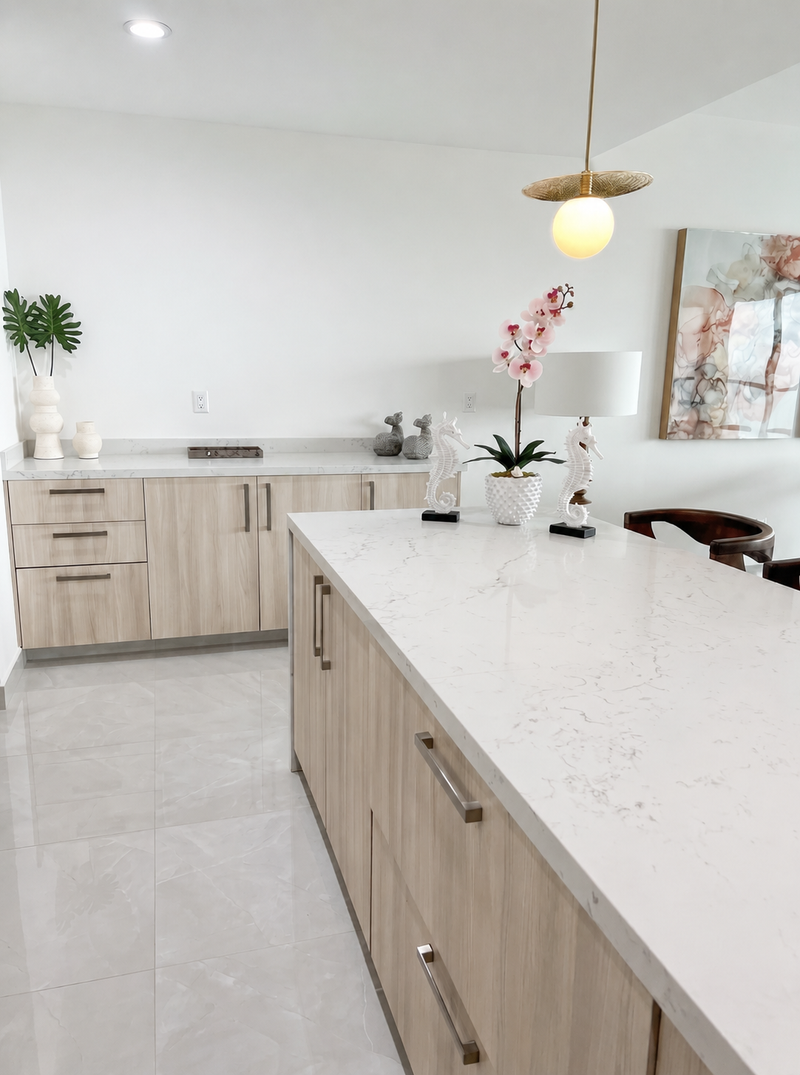 Light oak kitchen with a quartz waterfall island and integrated cabinet hardware