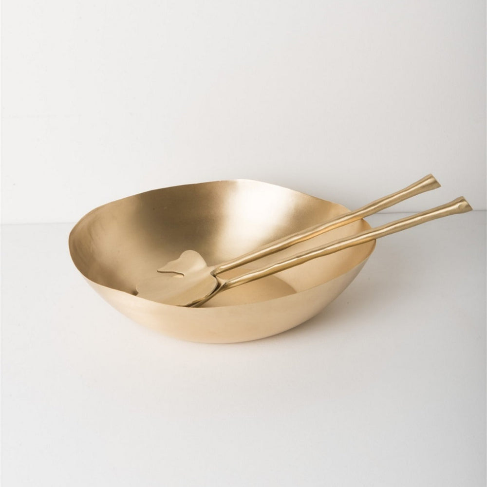 Gold bowl and spoons on a white background