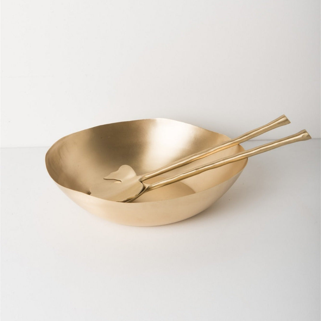Gold bowl and spoons on a white background