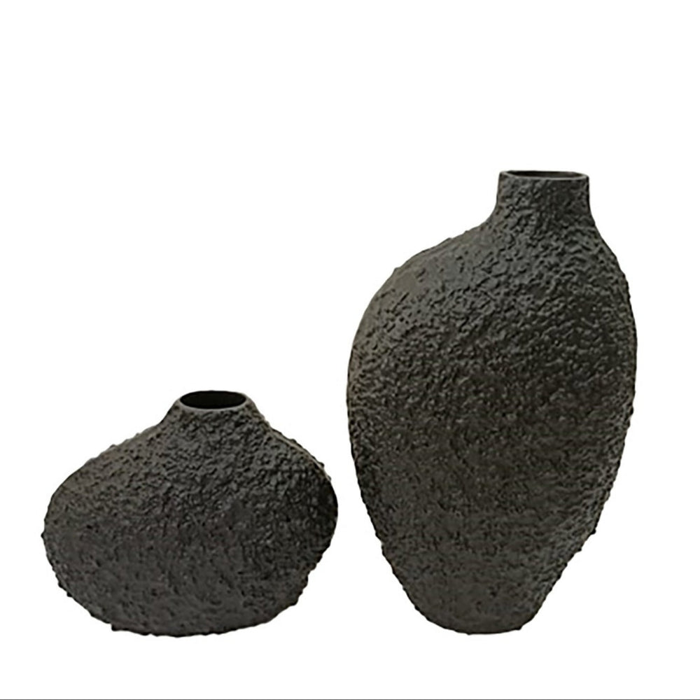 Two textured black vases on a white background
