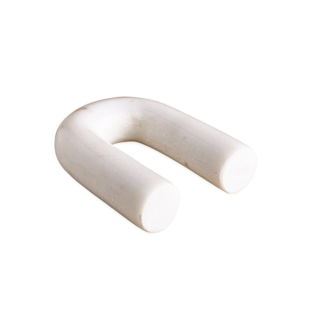 White arch-shaped marble figurine on a white background