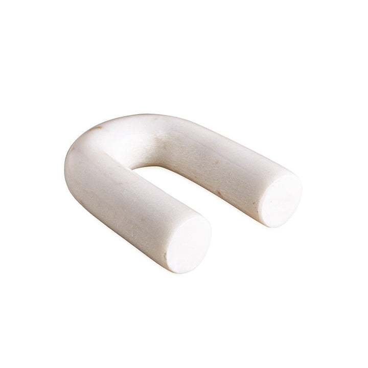 White arch-shaped marble figurine on a white background