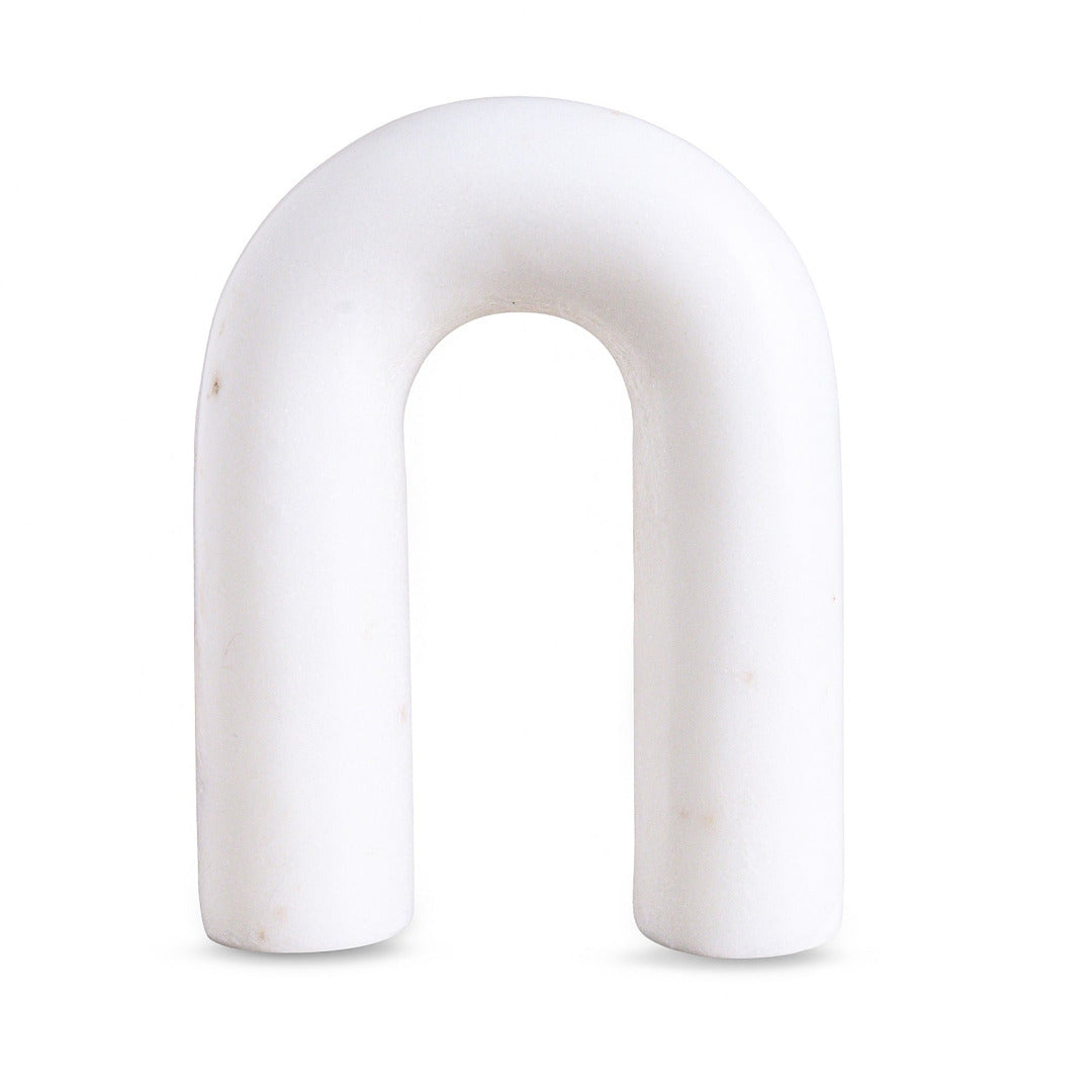 White arch-shaped marble figurine on a white background