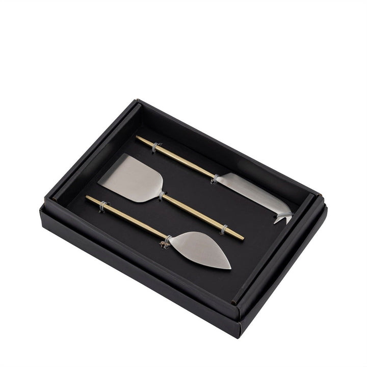 Set of three metal cheese knives in a black box on a white background